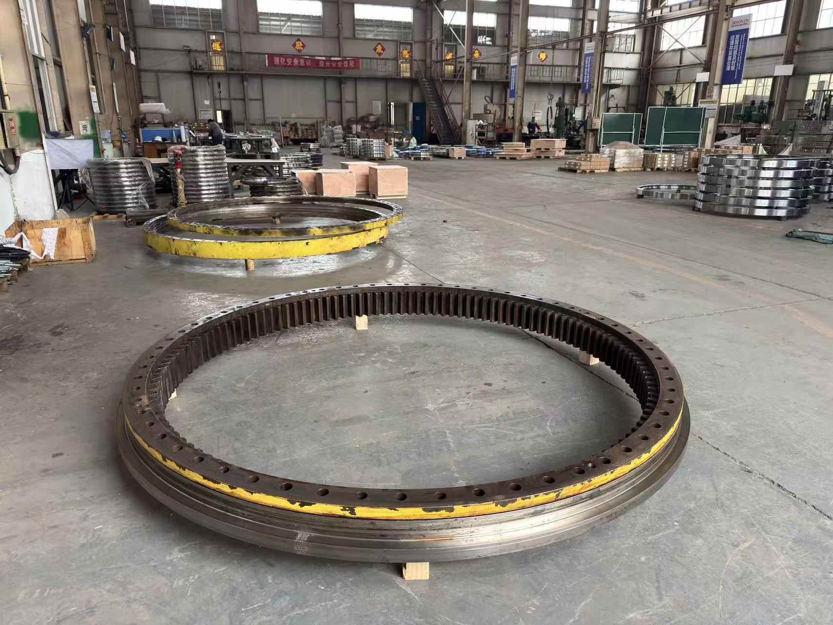 Disassembled large three-row roller slewing bearing rings inside the MERYDOM factory.